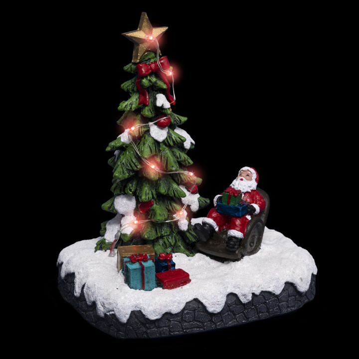 Village de Noël lumineux Père noël dans son fauteuil autour d'un sapin 